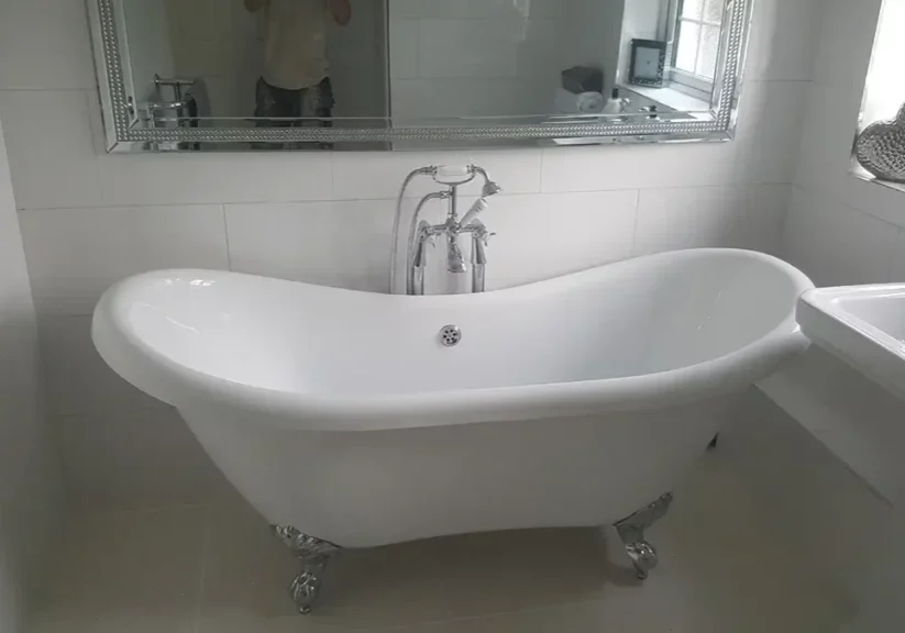 Modern bathroom fitting in braintree with a freestanding tub and marble effect tiles.
